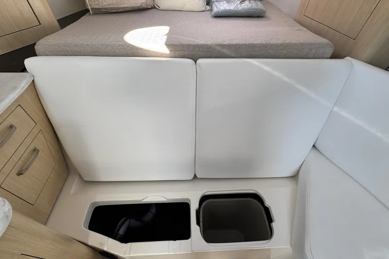 Slide: The Image of 2026 Regal 33 XO interior with storage compartments and seating area. - 102