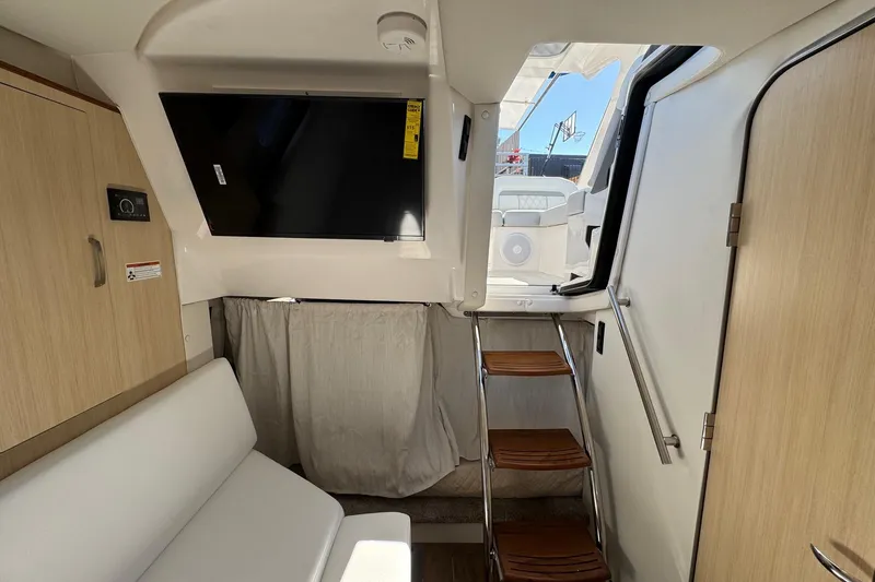 Slide: The Image of Interior of 2026 Regal 33 XO boat with modern seating and wooden steps. - 112