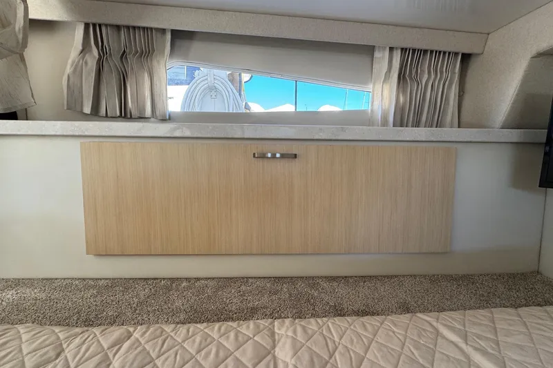 Slide: The Image of Interior of 2026 Regal 33 XO yacht with wooden cabinetry and window view. - 118