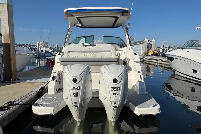 Slide: The Image of 2026 Regal 33 XO boat with twin 350 V6 engines docked at marina. - 13