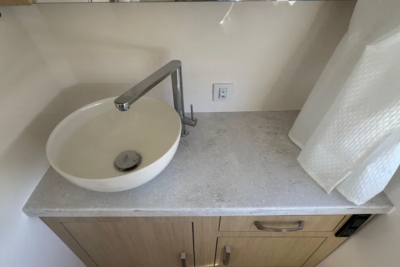 Slide: The Image of Modern bathroom sink with sleek faucet on Regal 33 XO 2026 boat. - 130
