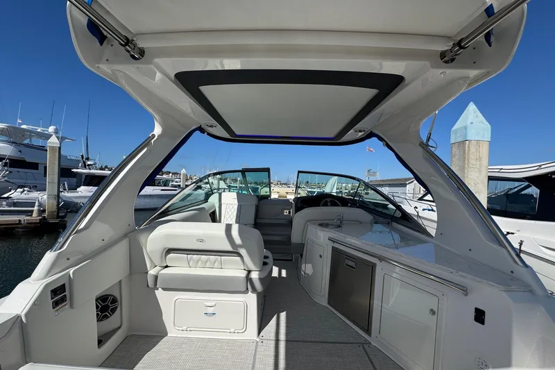 Slide: The Image of 2026 Regal 33 XO boat interior with seating and kitchenette, docked at marina. - 22