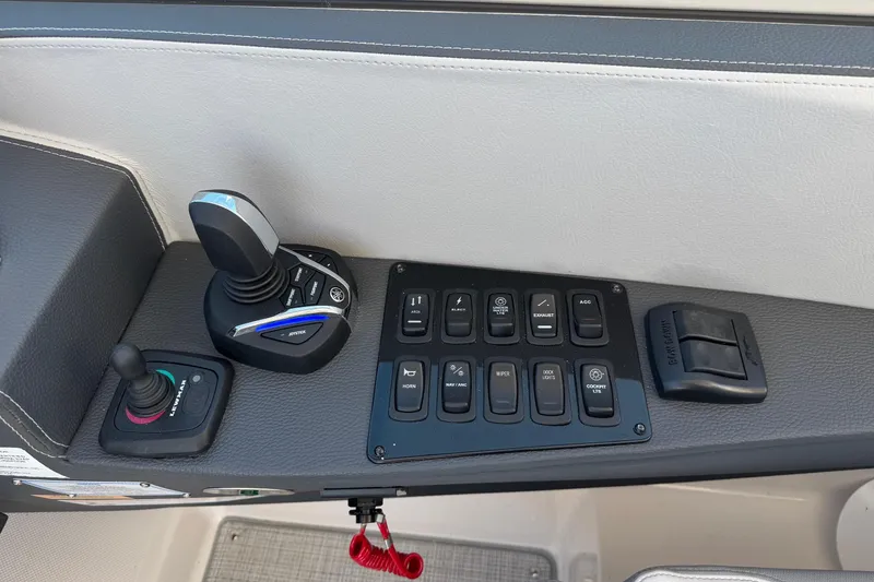 Slide: The Image of 2026 Regal 33 XO boat control panel with joystick and switches. - 52