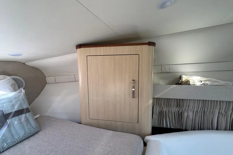 Slide: The Image of Interior cabin of 2026 Regal 33 XO boat with wooden cabinet and bedding. - 95