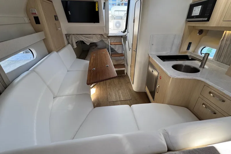 Slide: The Image of Luxurious interior of 2026 Regal 33 XO yacht with modern kitchen and seating area. - 98