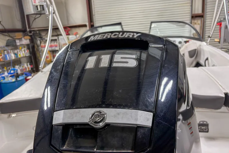 Slide: The Image of Mercury 115 outboard motor on 2023 Tahoe 185 S boat in garage setting. - 11