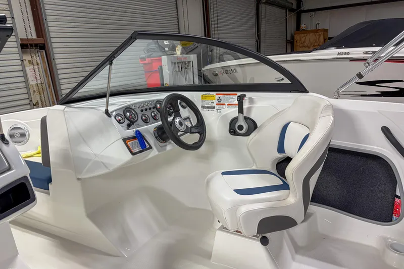 Slide: The Image of 2023 Tahoe 185 S boat interior with steering wheel and captain's seat. - 12