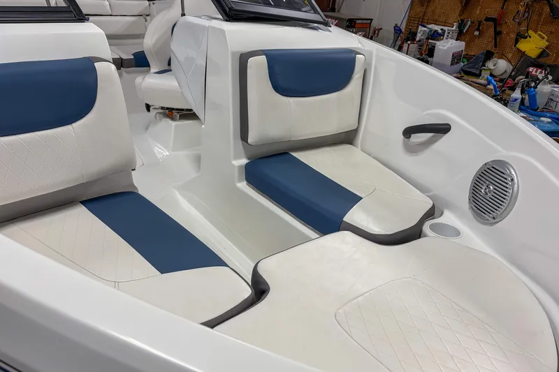 Slide: The Image of 2023 Tahoe 185 S boat interior with blue and white seating, featuring modern design. - 2