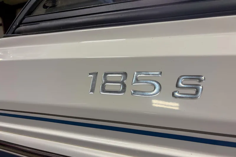 Slide: The Image of Close-up of 2023 Tahoe 185 S model emblem on white surface. - 3