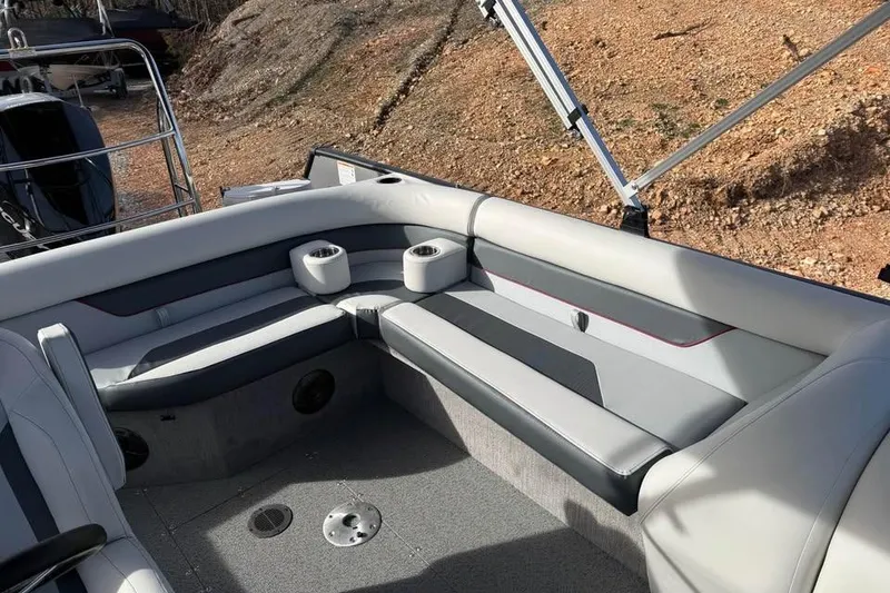 Slide: The Image of Interior of 2026 Lowe Sport Deck 224 boat with cushioned seating and cup holders. - 11