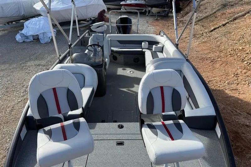 Slide: The Image of 2026 Lowe Sport Deck 224 boat interior with seating and steering console. - 14