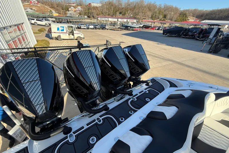 Slide: The Image of Four powerful outboard motors on a 2021 MTI 42V boat, parked at a marina. - 10