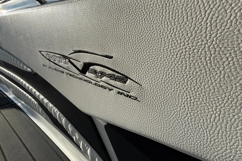 Slide: The Image of MTI 42V 2021 model logo on textured leather surface. - 29