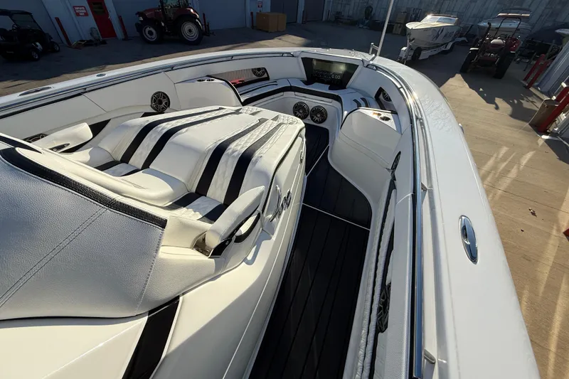 Slide: The Image of 2021 MTI 42V boat interior with sleek white seating and modern dashboard. - 30