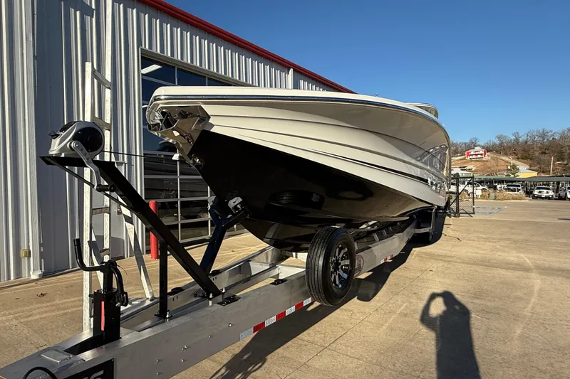 Slide: The Image of 2021 MTI 42V boat on trailer outside a metal building, clear sky background. - 5