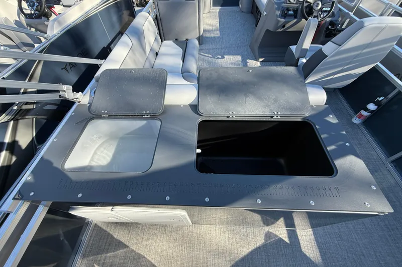 Slide: The Image of 2026 Tahoe Pontoon Sport 85 Rear Fish interior with open storage compartments. - 8
