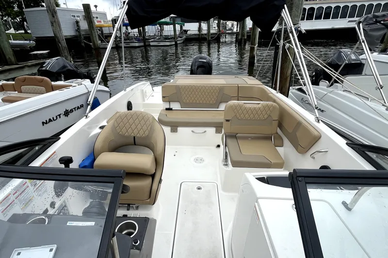 Slide: The Image of 2025 Bayliner VR6 Bowrider OB with tan seating, docked at marina. - 4