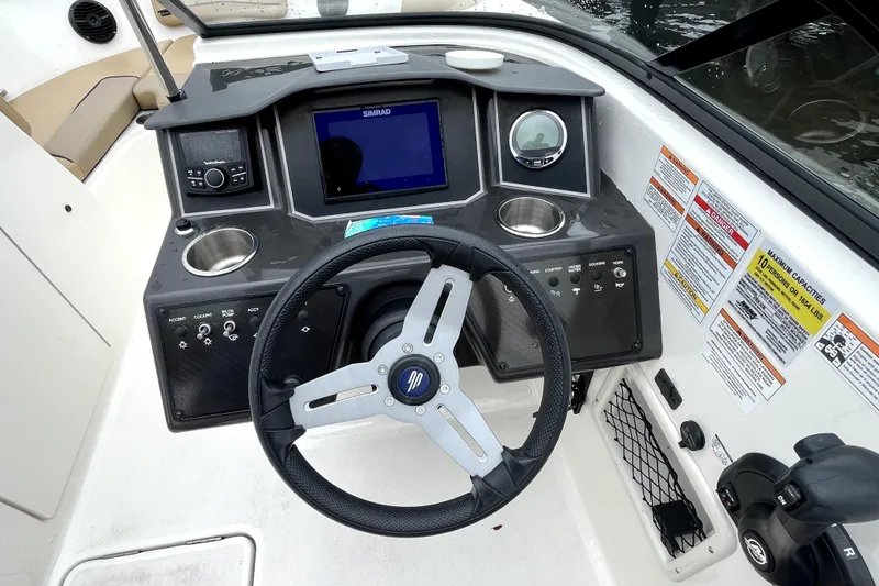 Slide: The Image of 2025 Bayliner VR6 Bowrider OB dashboard with steering wheel, controls, and navigation display. - 6