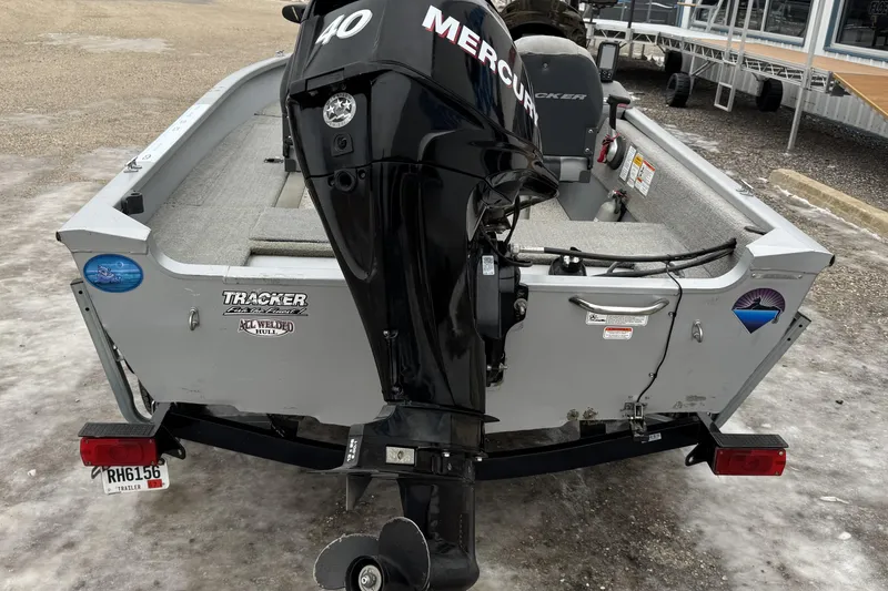 Slide: The Image of 2010 Tracker Pro Guide V-15 SC boat with Mercury 40 engine, parked on icy ground. - 5