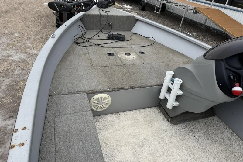 Slide: The Image of 2010 Tracker Pro Guide V-15 SC boat interior with fishing rod holders and speaker. - 6