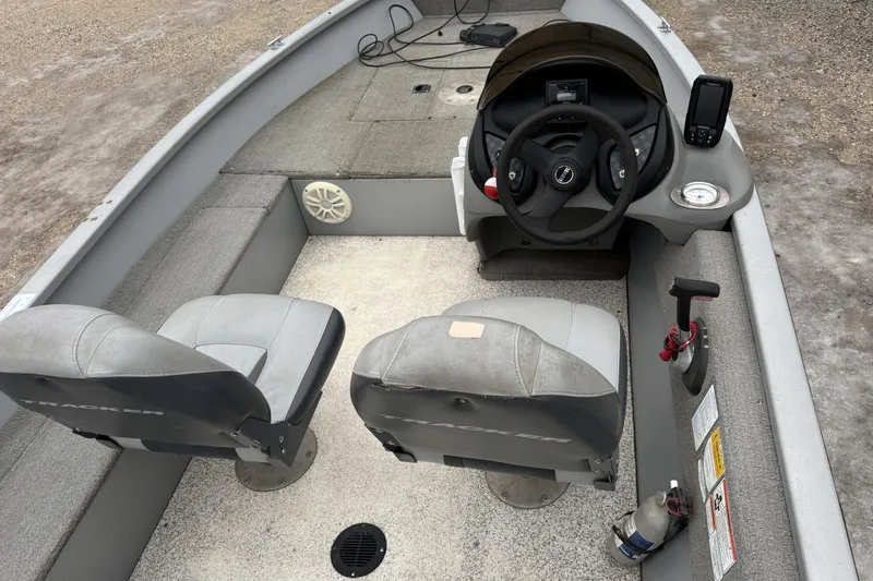 Slide: The Image of 2010 Tracker Pro Guide V-15 SC boat interior with steering wheel and seating. - 7
