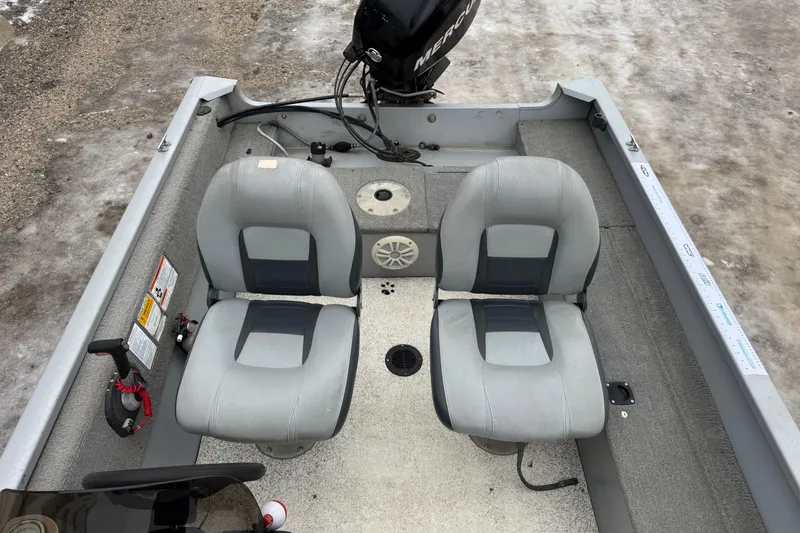 Slide: The Image of 2010 Tracker Pro Guide V-15 SC boat interior with two seats and a Mercury motor. - 8