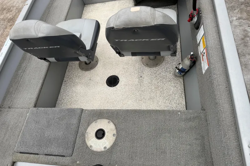 Slide: The Image of 2010 Tracker Pro Guide V-15 SC boat interior with two seats and carpeted floor. - 9