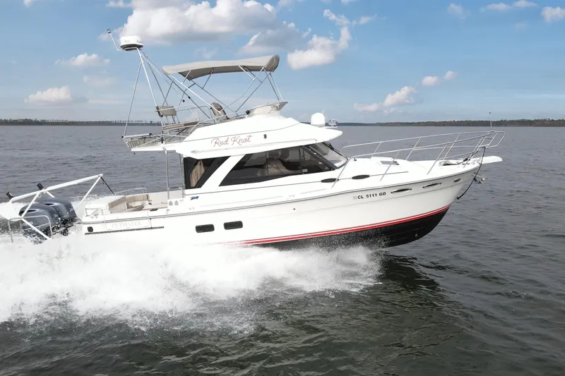 The Image of 2021 Cutwater C-32 CB boat cruising on open water under a clear sky. - 0