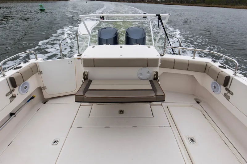 Slide: The Image of 2021 Cutwater C-32 CB boat deck with seating and twin engines on water. - 12