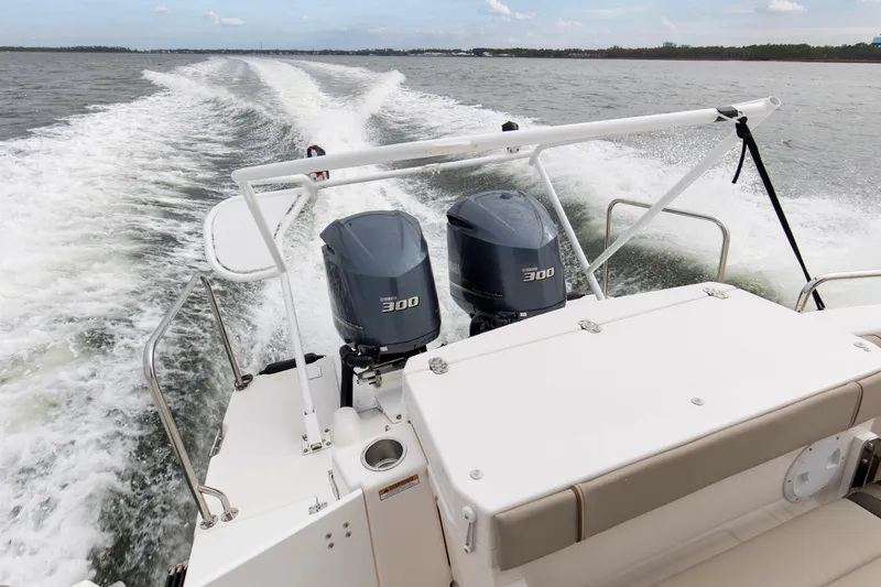 Slide: The Image of 2021 Cutwater C-32 CB boat with dual 300 horsepower engines cruising on open water. - 13