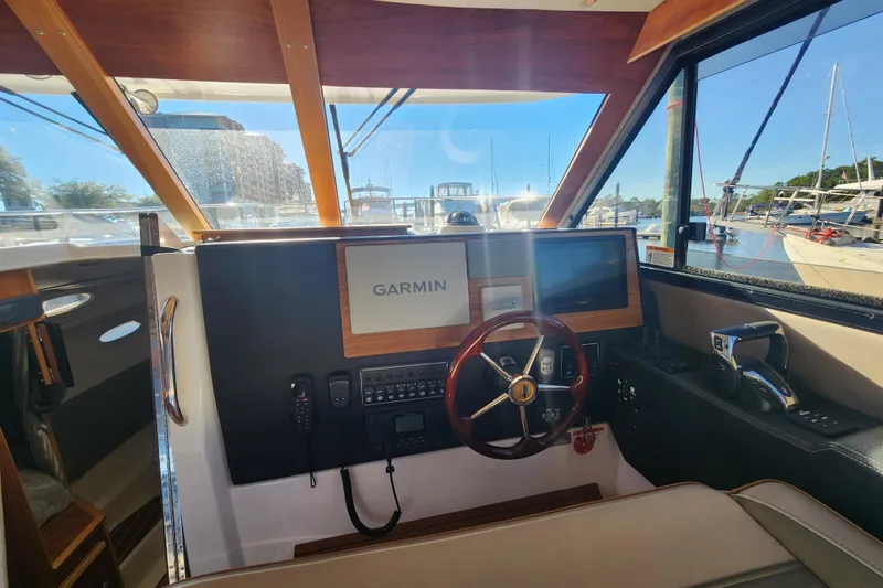 Slide: The Image of 2021 Cutwater C-32 CB helm with Garmin navigation, docked at marina. - 16