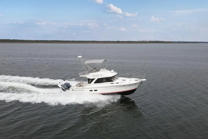 Slide: The Image of 2021 Cutwater C-32 CB cruising on open water under a clear sky. - 2