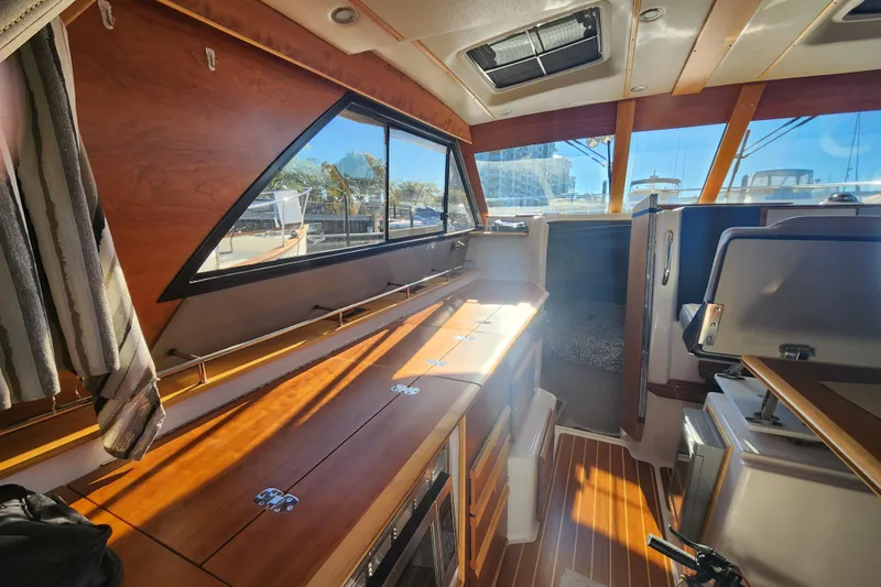 Slide: The Image of Interior of 2021 Cutwater C-32 CB boat with wood finishes and ample natural light. - 22