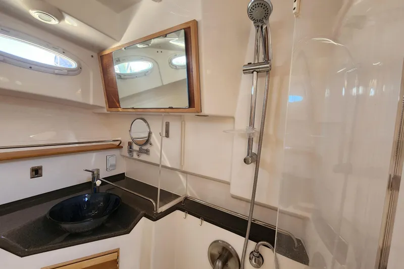 Slide: The Image of 2021 Cutwater C-32 CB yacht bathroom with modern sink, shower, and mirror. - 25