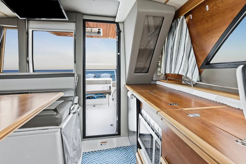 Slide: The Image of Interior of 2021 Cutwater C-32 CB boat with modern kitchen and ocean view. - 31