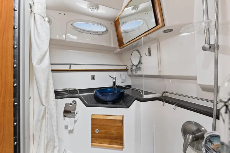 Slide: The Image of 2021 Cutwater C-32 CB boat bathroom with modern sink, mirror, and shower. - 40