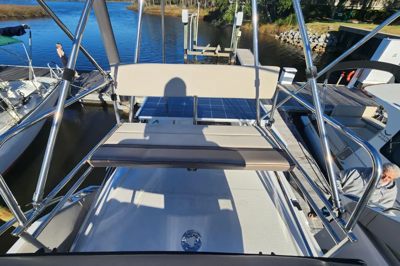 Slide: The Image of 2021 Cutwater C-32 CB boat at dock, featuring upper deck seating and stainless steel railings. - 45