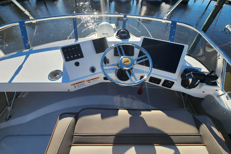 Slide: The Image of 2021 Cutwater C-32 CB boat helm with steering wheel and navigation screens. - 47