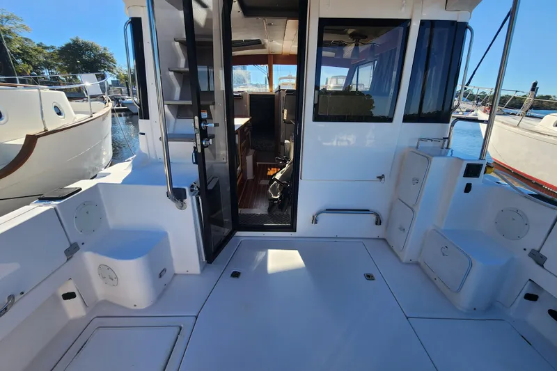 Slide: The Image of 2021 Cutwater C-32 CB boat interior with open cabin door, docked at marina. - 6