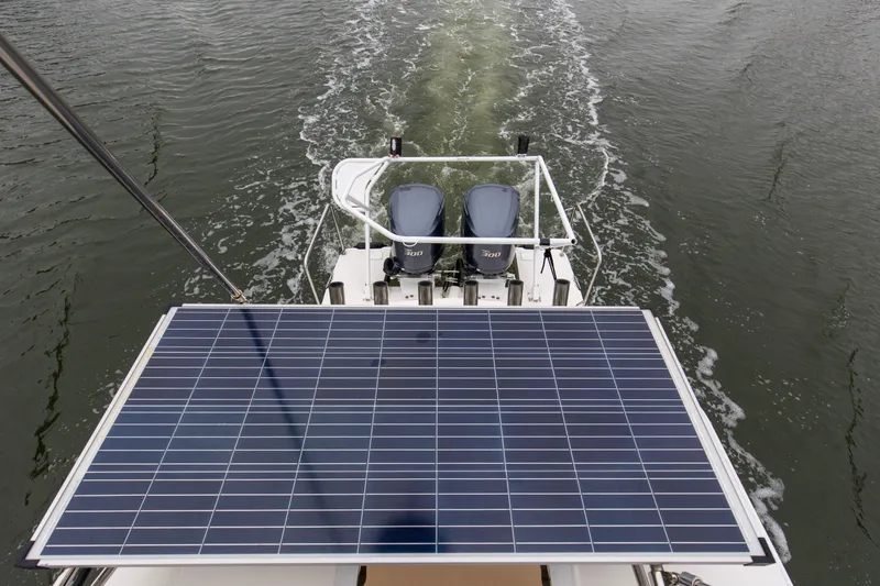 Slide: The Image of 2021 Cutwater C-32 CB boat with solar panel and dual outboard motors on water. - 63
