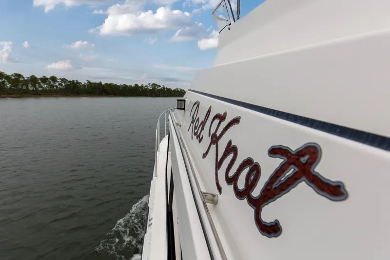 Slide: The Image of 2021 Cutwater C-32 CB boat cruising on a calm lake under a partly cloudy sky. - 65