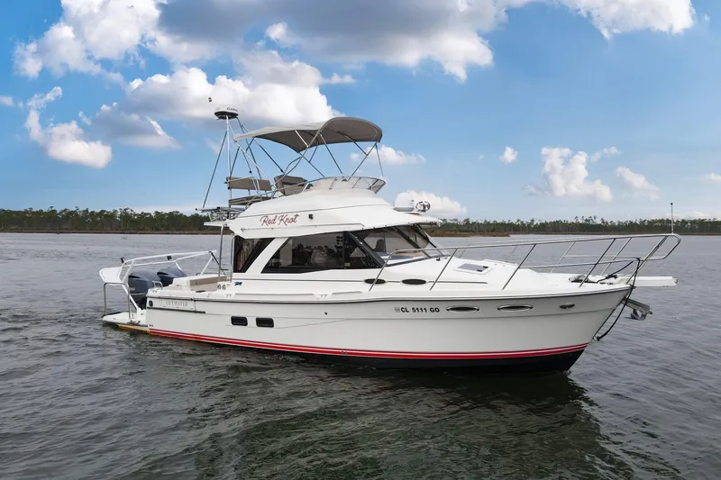 Slide: The Image of 2021 Cutwater C-32 CB boat on calm water under a blue sky. - 66