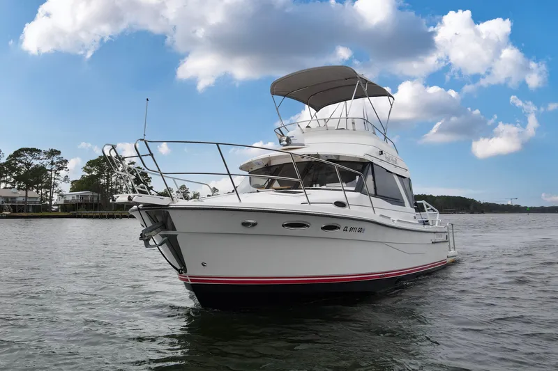 Slide: The Image of 2021 Cutwater C-32 CB boat on water under a partly cloudy sky. - 67