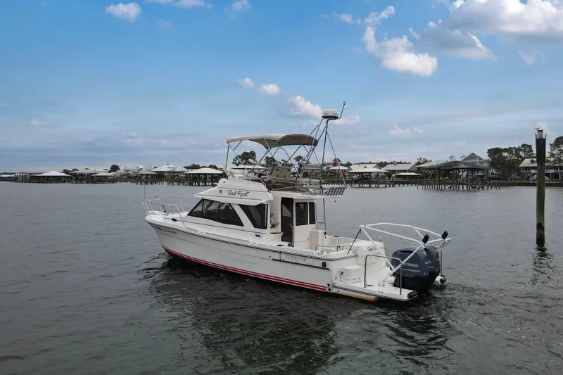Slide: The Image of 2021 Cutwater C-32 CB boat on calm water with coastal background. - 68