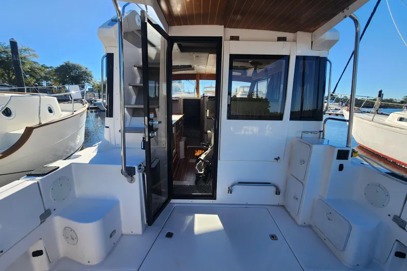 Slide: The Image of 2021 Cutwater C-32 CB boat interior with open door, docked at marina. - 70