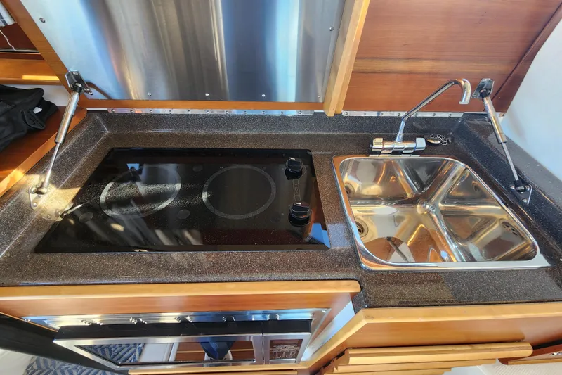 Slide: The Image of 2021 Cutwater C-32 CB kitchen with stove and dual sink setup. - 75