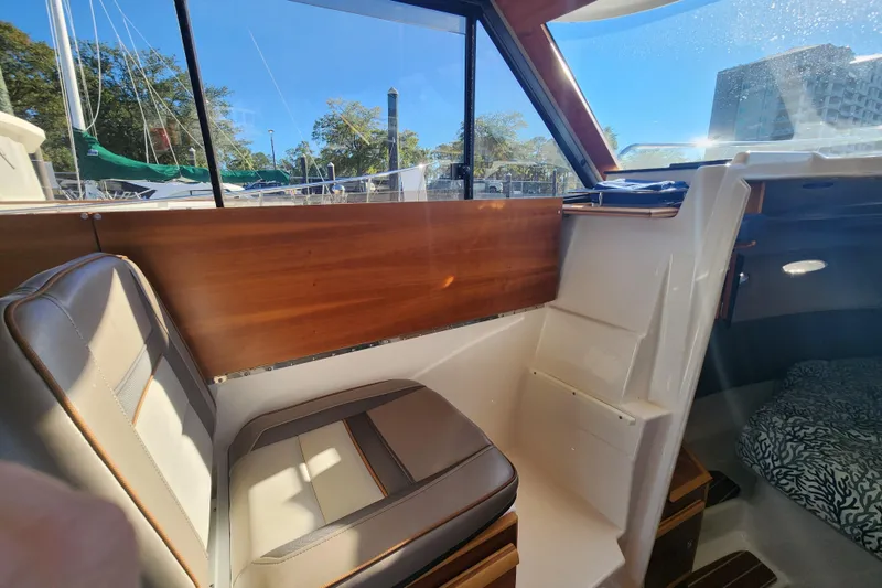 Slide: The Image of 2021 Cutwater C-32 CB interior with wood paneling and cushioned seating. - 78