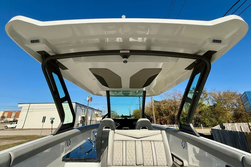 Slide: The Image of 2026 Monterey Elite 30 OB boat with sleek design and sunshade. - 13
