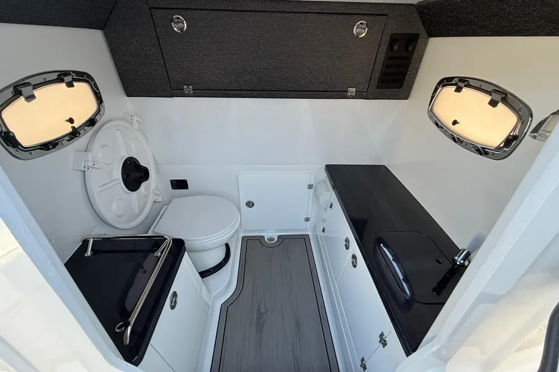 Slide: The Image of Interior of 2026 Monterey Elite 30 OB with toilet and sink. - 19
