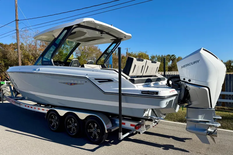 Slide: The Image of 2026 Monterey Elite 30 OB boat on trailer, side view. - 2